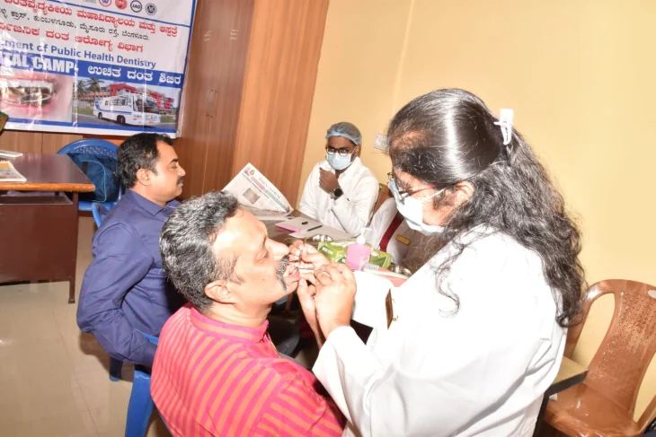A healthcare professional conducting an oral screening